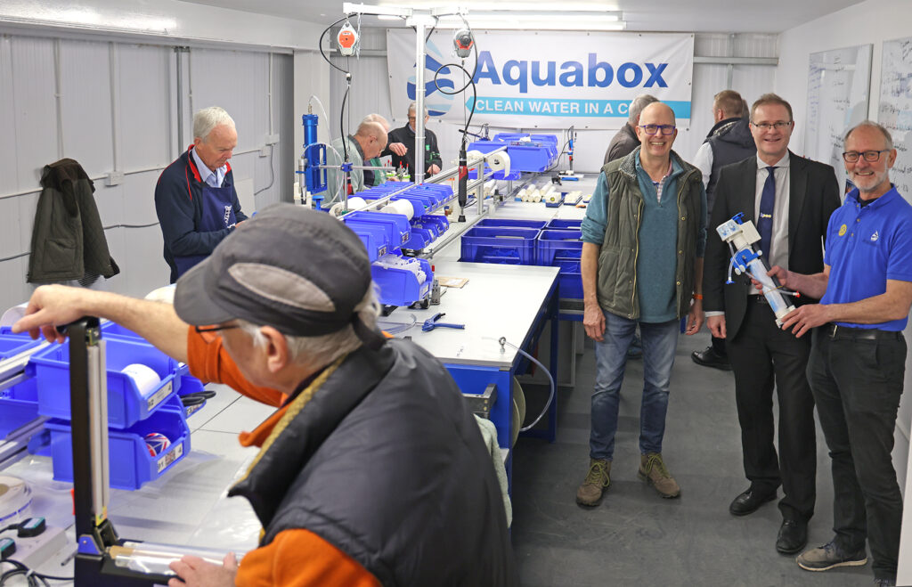 Neil Collishaw from BPEC with Roger and Dominic in the assembly room with volunteers